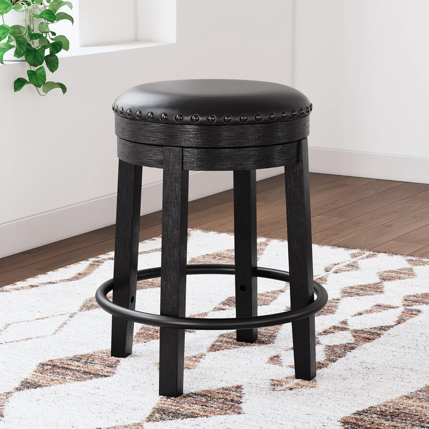 Signature Design by Ashley Valebeck Casual Round Faux Leather Upholstered Backless Counter Height Bar Stool with Footrest and Nailhead Trim, Black
